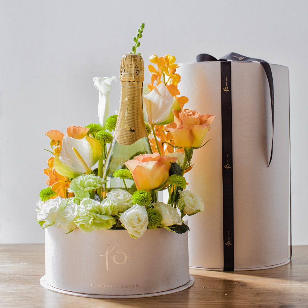 Hidden within our signature cylinder box is a garden of blooms surrounding a bottle of delicious sparkling wine - perfect for celebrations, corporate gifts, and romantic gestures! 20cmW x 35cmH