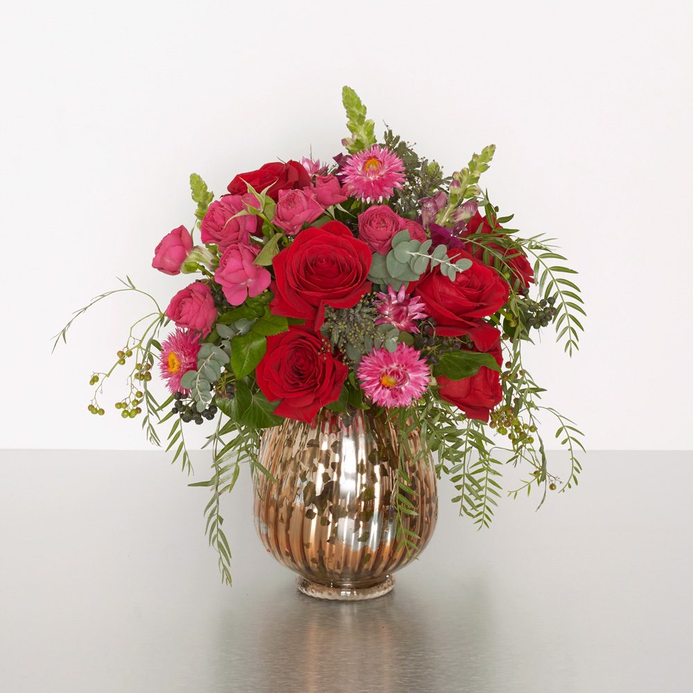 Deep-in-thought red and pink roses, in our copper-accented glass vase, make for a lovely gift for any romantic occasion. 25cmW x 35cmH